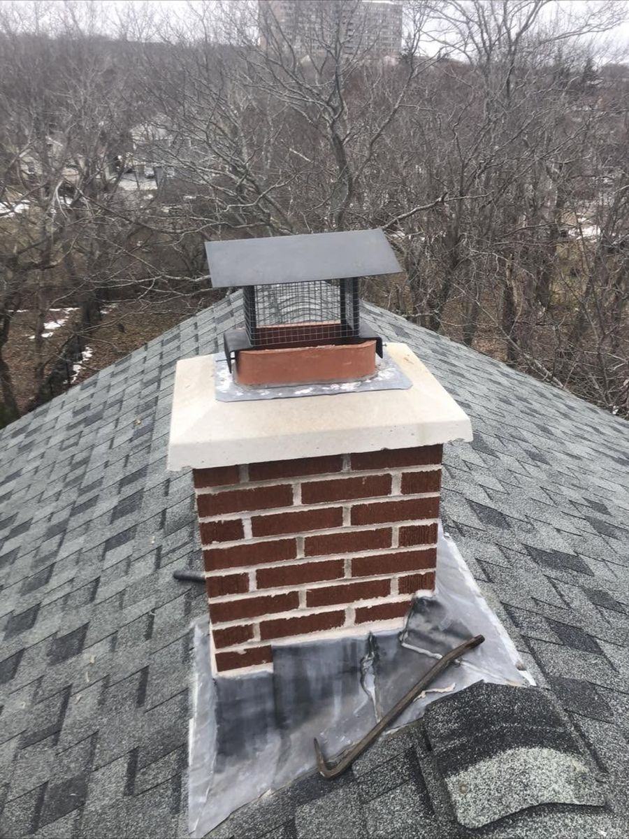 Brick chimney rebuilt above the roofline with a new cast crown, flashing and rain cap